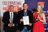 Anna Knutsen and Brad Hill (Riverway Foods) receiving their Gold Award from Phil Vickery.