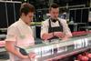 WorldSkills winner Peter Rushforth teaching Crosby Management Training trailblazer apprentice Stephen Maltby how to make a whole chicken cushion.