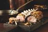 Cooked lamb rack on a board