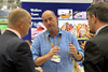 Minister KevinHollinrake speaking to a Pork exporter on the AHDB red meat stand Copy