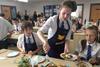 Y8 Pupils serve their cottage pie to the rest of the year group. Nigel Winn from Owen Taylors chatting to Headteacher dr Hobbs in background  1