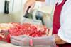 Butcher slicing meat