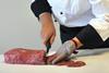 Chef cutting beef fillet