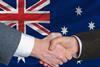 Handshake in front of Australian flag