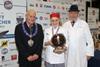 Winner of the Premier Young Butcher Competition, Lucy Crawshaw with NFMFT president Jim Sperring (left) and chief judge from the Institute of Meat, Keith Fisher (right).