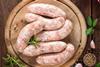 Raw sausages on a board