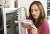 Concerned Woman Looking At Pre Packaged Meat