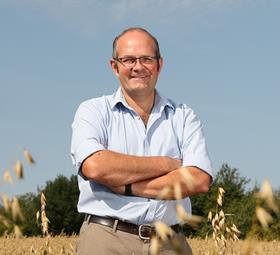 NFU president Tom Bradshaw standing in a wheat field.