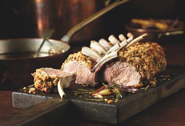 Cooked lamb rack on a board