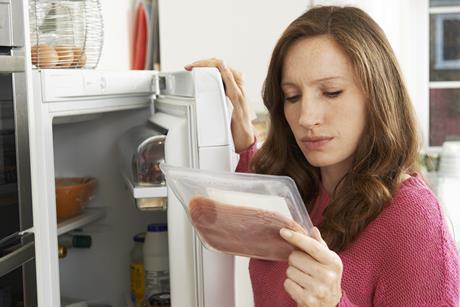 Woman looking at meat packaging