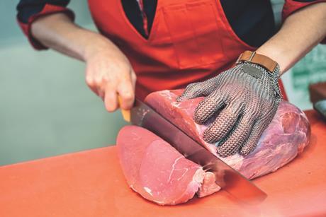 Butcher cutting meat