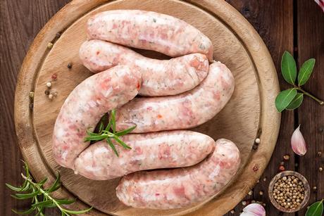 Raw sausages on a board