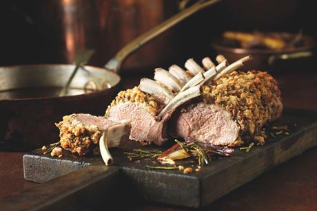 Cooked lamb rack on a board