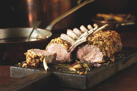Cooked lamb rack on a board