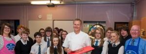 Chef Nick Nairn with pupils of Woodmill High School flanked by Jennifer Robertson, QMS Health and Education Coordinator, and Alex Mitchell, Fife Butcher.