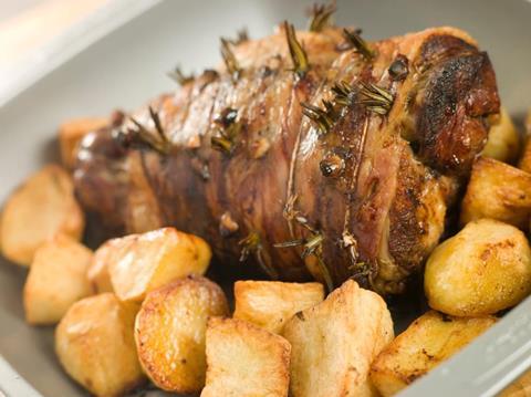 Roast leg of lamb studded with garlic and rosemary and roast potatoes.