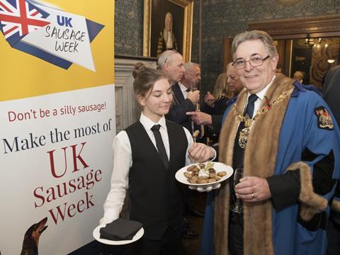 Master of The Worshipful Company of Butchers Geoff Gillo enjoying the sausage canapes. 