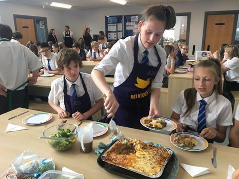 Y8 Pupils serve their cottage pie to the rest of the year group. Nigel Winn from Owen Taylors chatting to Headteacher dr Hobbs in background 