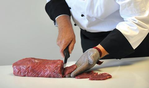 Chef cutting beef fillet