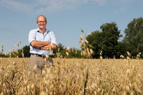 NFU president Tom Bradshaw standing in a wheat field.