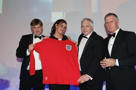 L-R: Professor Roger Kirby, representing the Urology Foundation with Fran White and Chris Price of Graham White & Co collecting their replica 1966 England shirt from Sir Geoff Hurst.