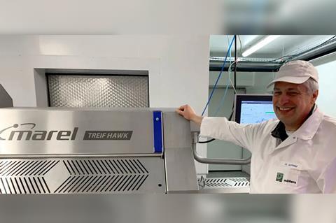 Helmut Schmid, production manager at Mollers stands beside the Marel TREIF HAWK.