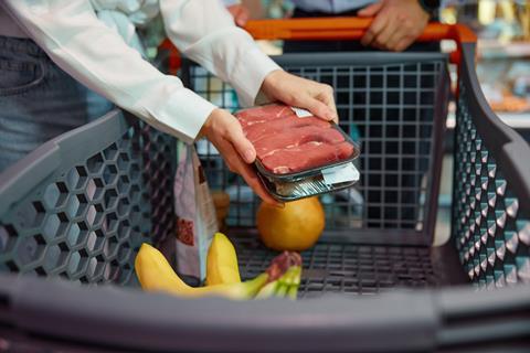 Shopper buying meat in a supermarket