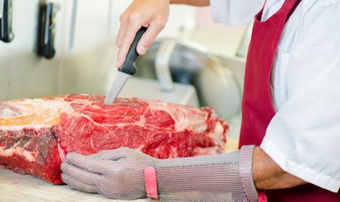 Butcher slicing meat