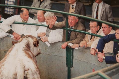 Roger Baker, pictured at Banbury market in 1998; he is centre, in the brown jacket, arm raised.